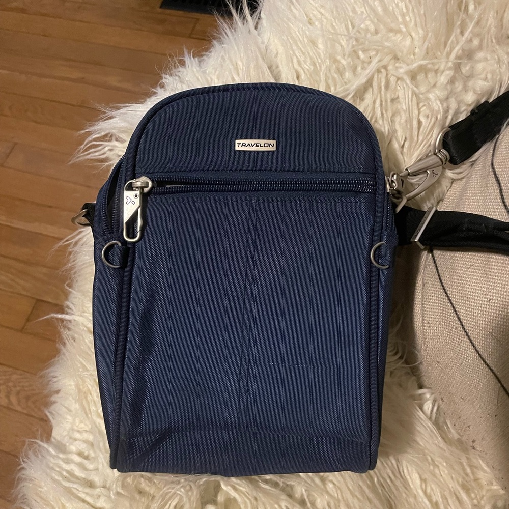 Travelon cross body bag with security lock strap and zippers, slash proof fabric